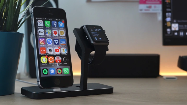 Smartphone and smartwatch docked on stand