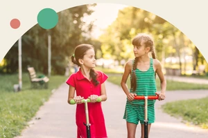 Two girls with scooters